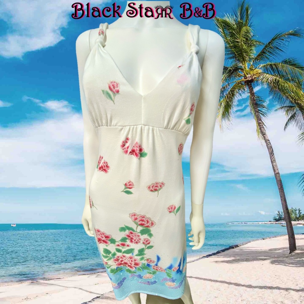 White knit 3/4” long dress with pink blue and green flower designs & sequins.